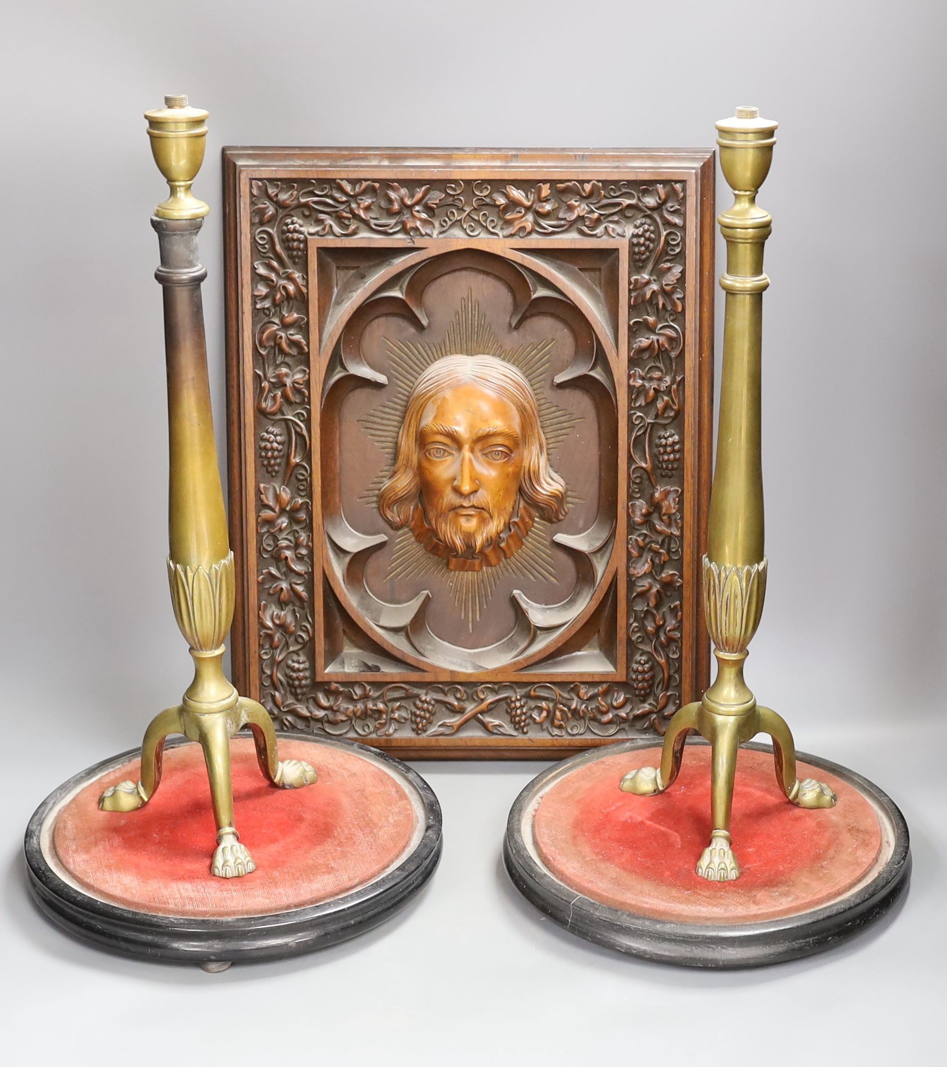 A late 19th century Continental heavily carved walnut and boxwood panel of Christ, a pair of brass lamp bases and two circular stands (5)